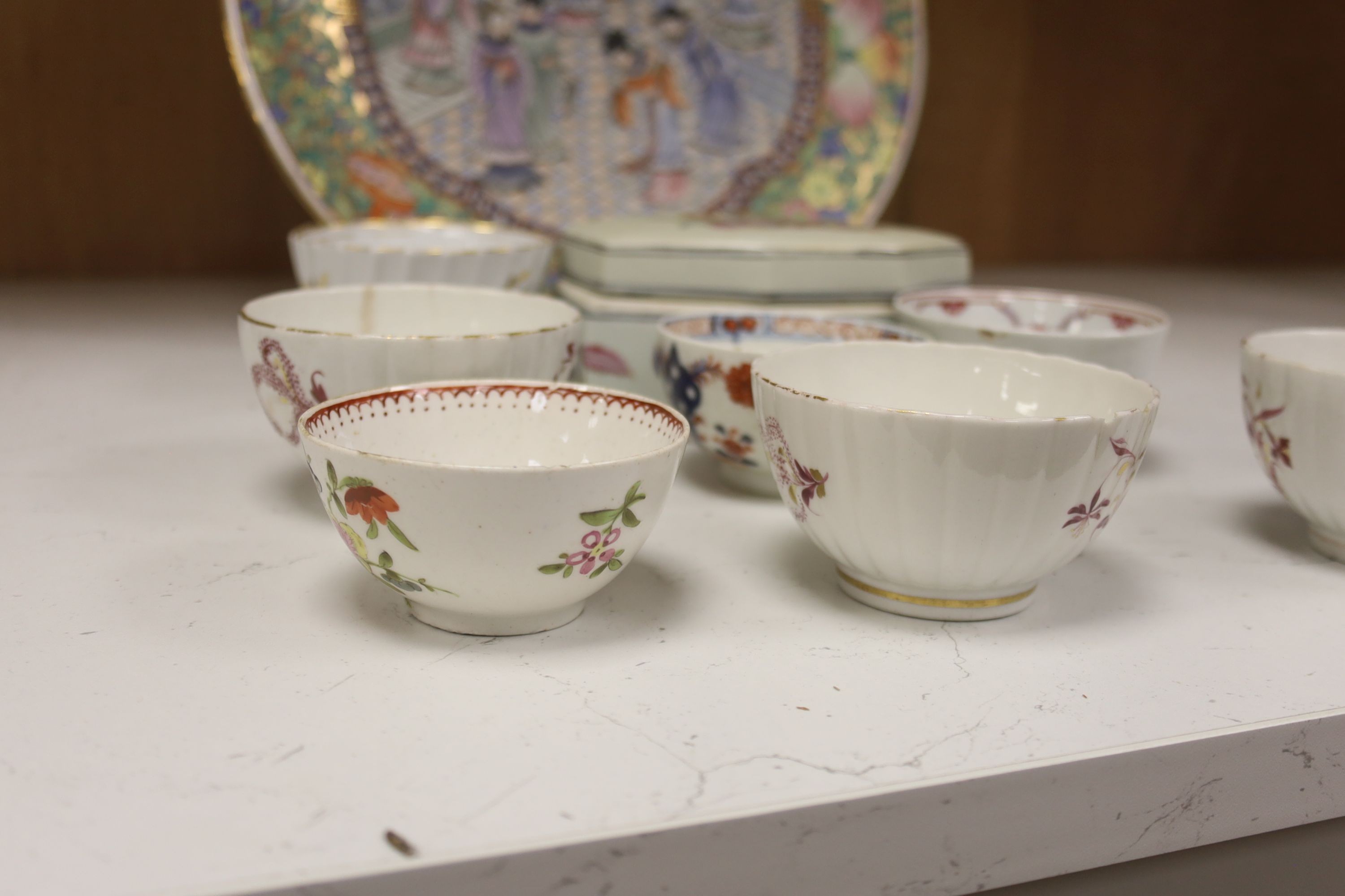 Seven 18th century English porcelain tea bowls, an armorial box and cover and a famille rose dish, diameter 30cm